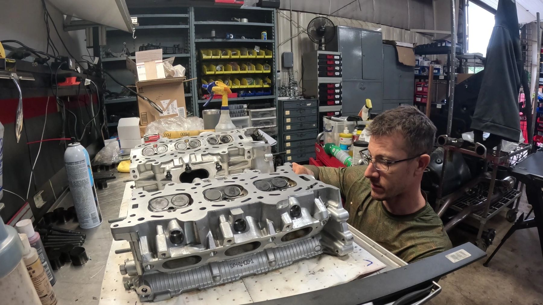 Technician inspecting cylinder heads at the bench